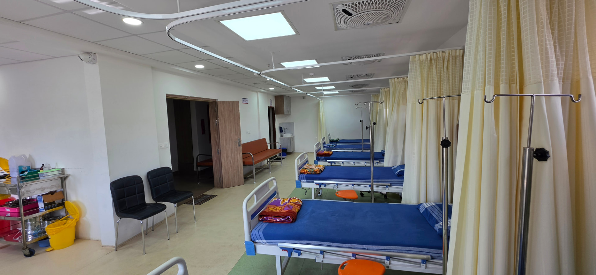 Inpatient ward with monitored beds and privacy curtains at Dr. Rakesh Medicare